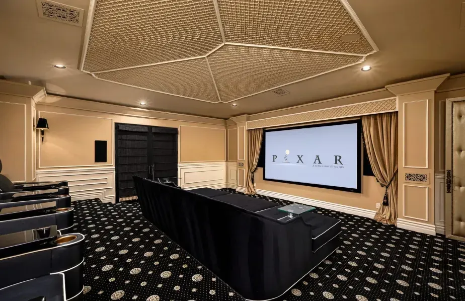 Home theater in a luxury custom home with comfortable seating and large screen