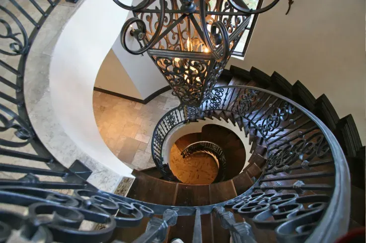 Custom spiral staircase emphasizing material texture, form, and architectural balance