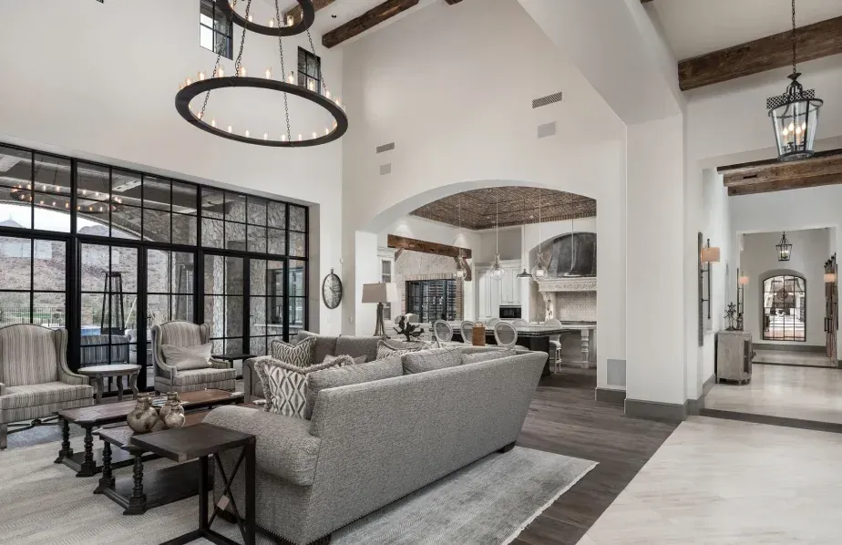 modern rustic living room interior with high ceiling wood beams and large windows