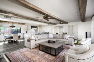 A living room filled with furniture and a rug.