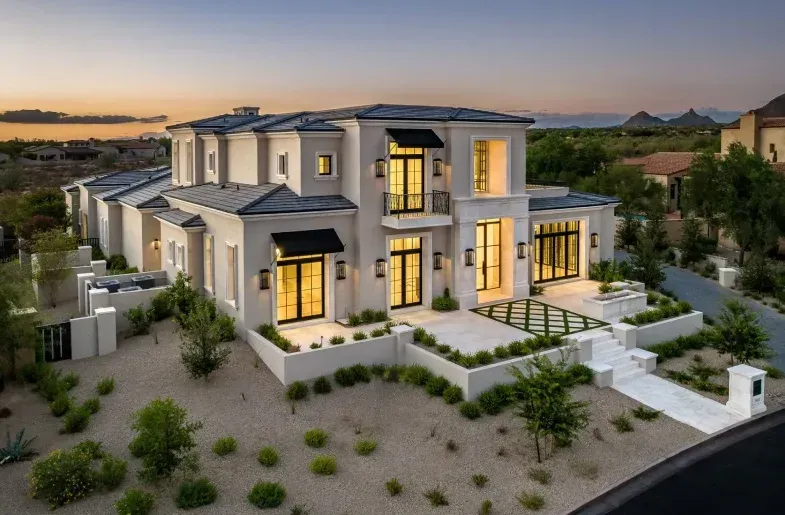 An aerial view of a large white house with a lot of windows