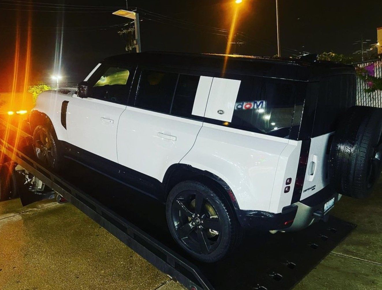 A white SUV on the back of a black tow truck in Bethesda MD