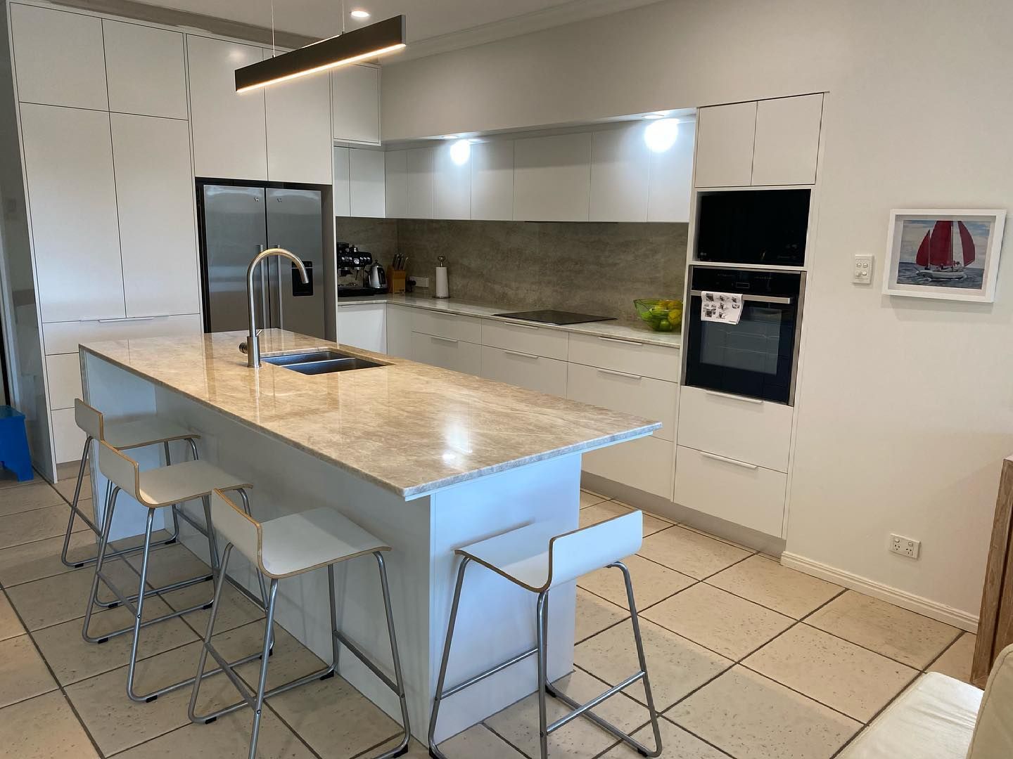 A Kitchen With a Large Island and Stools and a Picture of a Sailboat on the Wall — Expert Cabinetmaker on the Sunshine Coast QLD