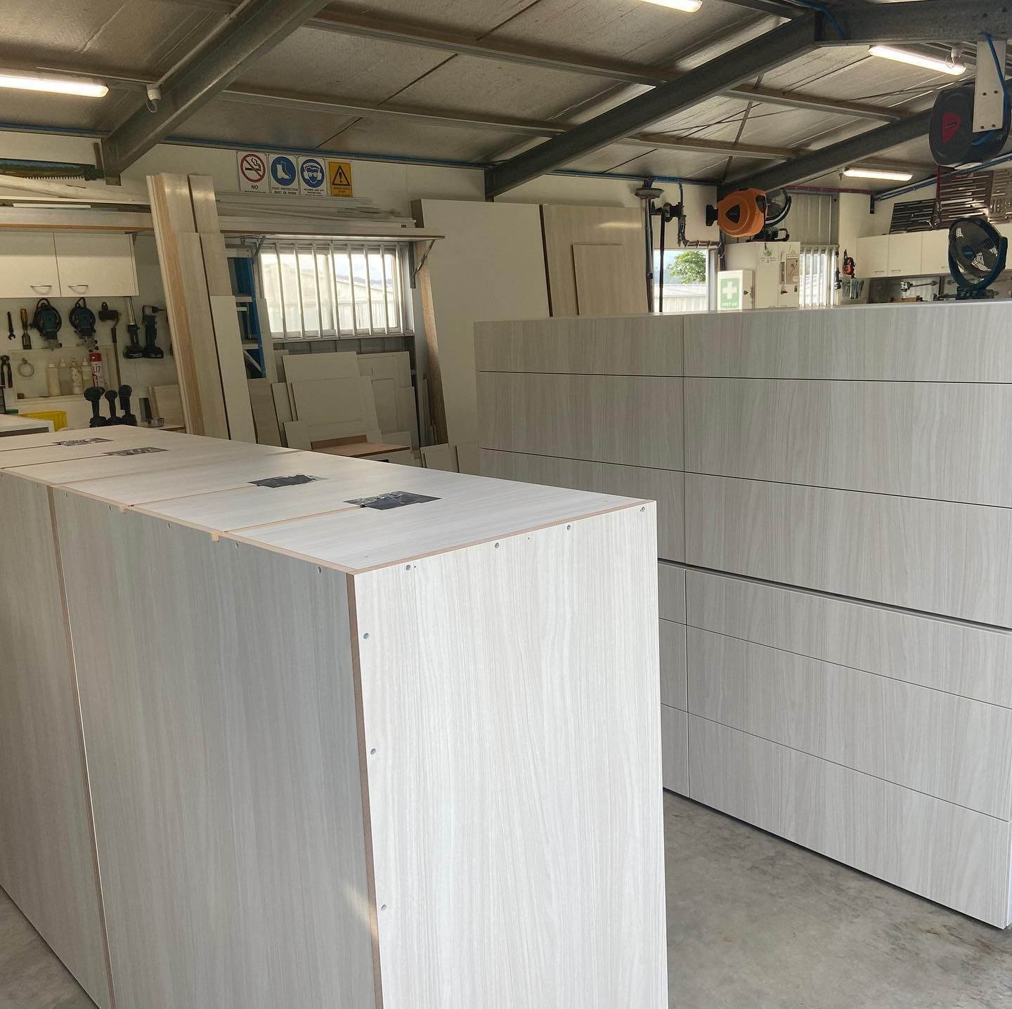A Warehouse Filled with Numerous White Cabinets — Expert Cabinetmaker on the Sunshine Coast QLD