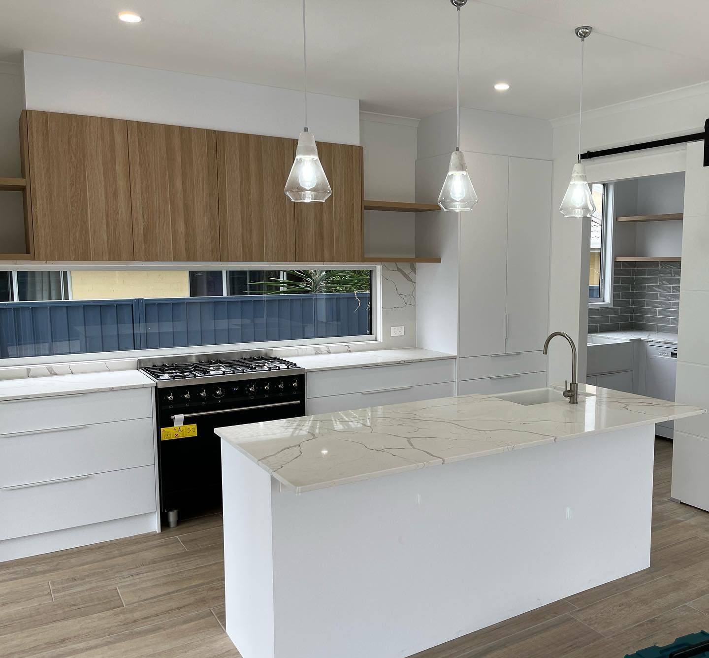 A Kitchen with a Spacious Island and Stove — Expert Cabinetmaker on the Sunshine Coast QLD