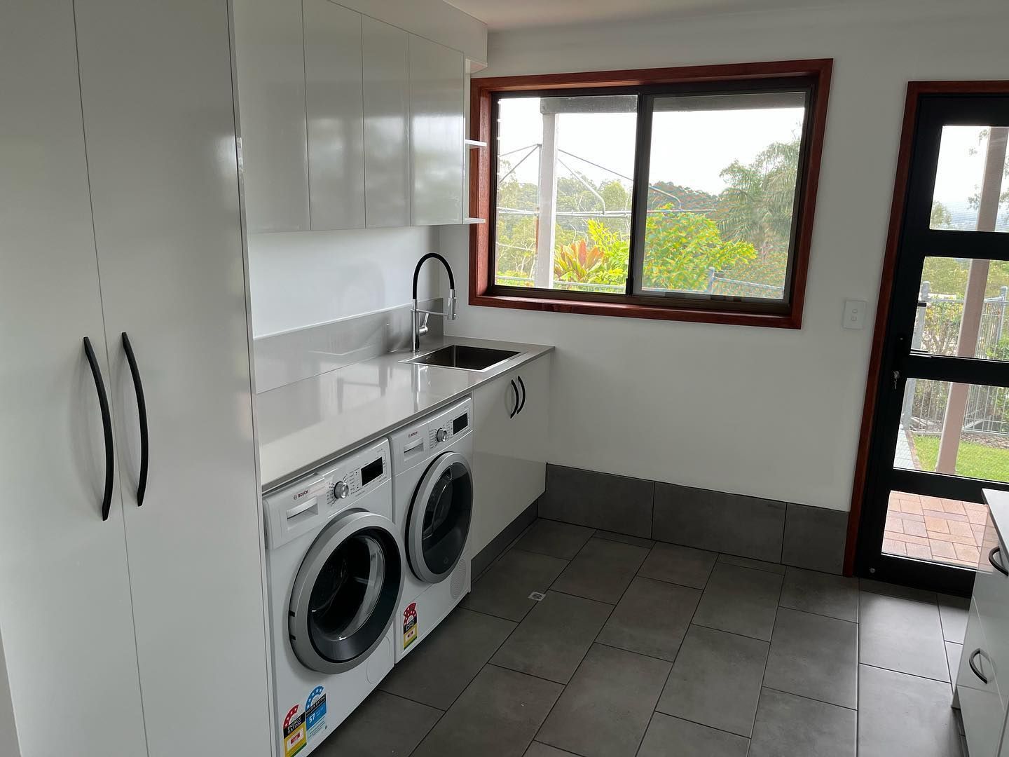 A Laundry Room with Washer, Dryer, and Sink — Expert Cabinetmaker on the Sunshine Coast QLD