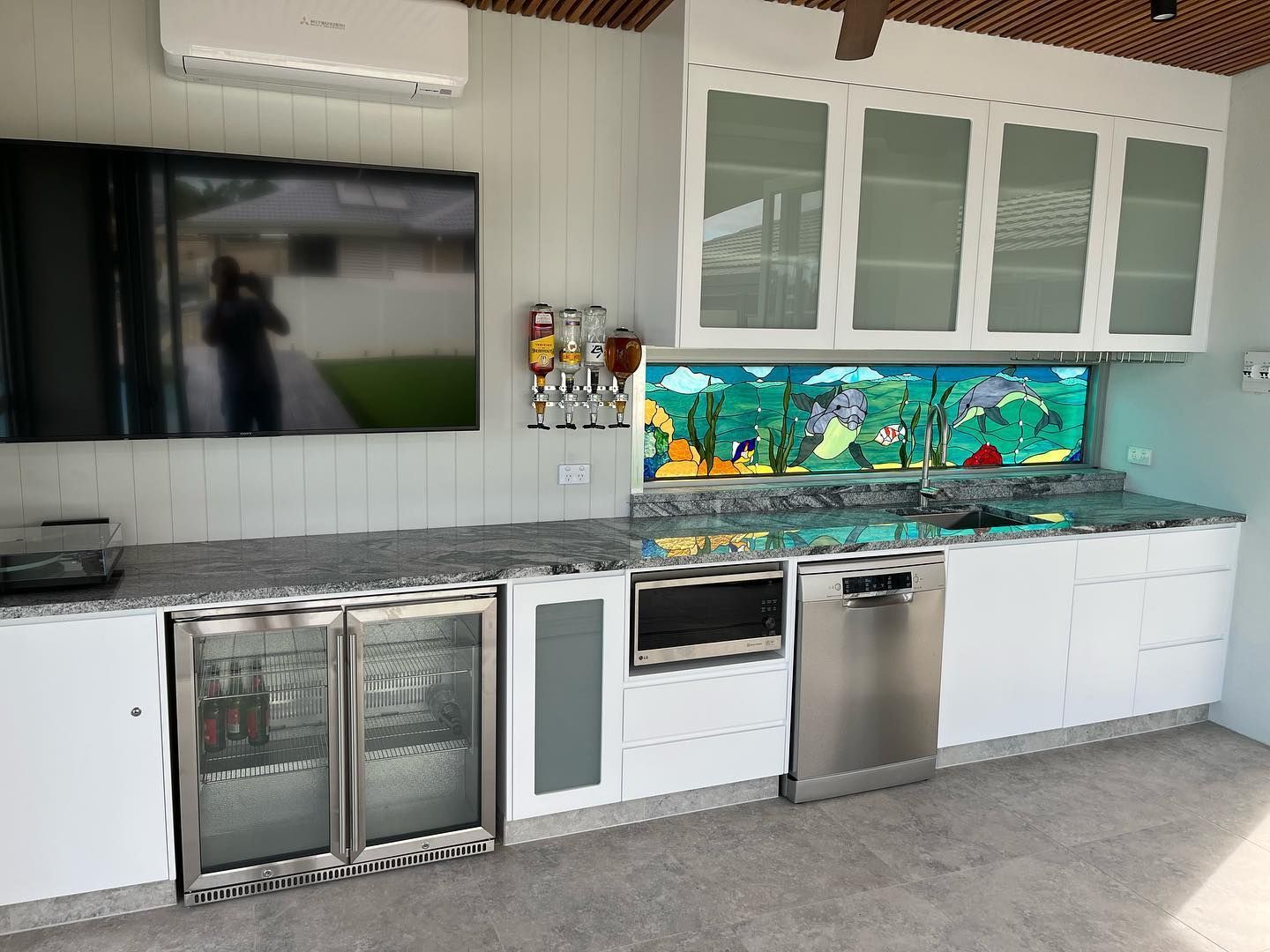 A Kitchen Featuring White Cabinets, Stainless Steel Appliances, and a Flat-Screen TV — Expert Cabinetmaker on the Sunshine Coast QLD