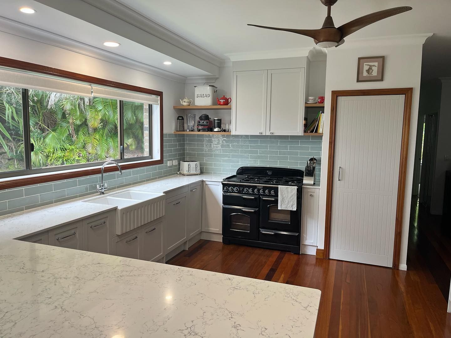 A Rustic Kitchen featuring a Stove, Sink, and Ceiling Fan — Expert Cabinetmaker on the Sunshine Coast QLD