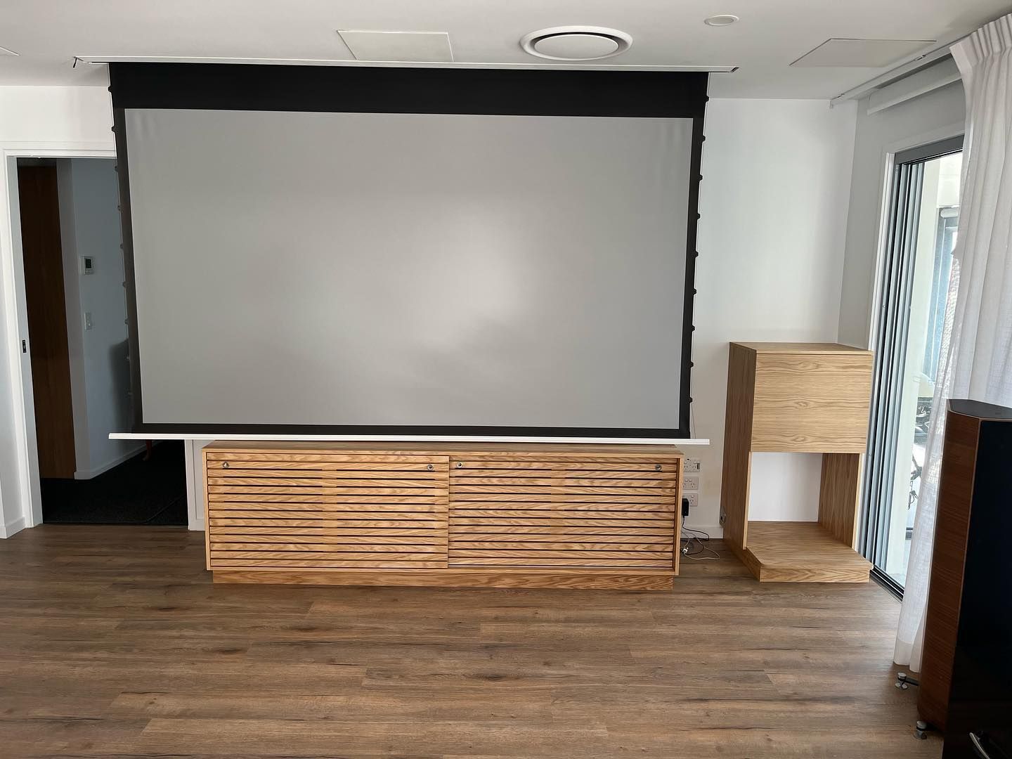 A Living Room Featuring a Projector Screen and Wooden Cabinet — Expert Cabinetmaker on the Sunshine Coast QLD