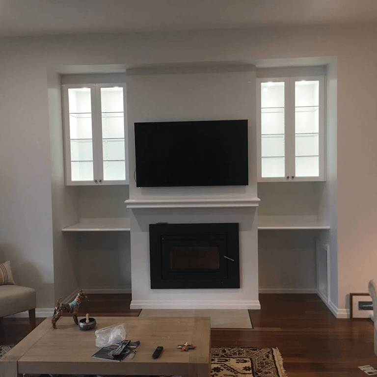 A Cosy Living Room with Fireplace and Flat Screen TV — Expert Cabinetmaker on the Sunshine Coast QLD
