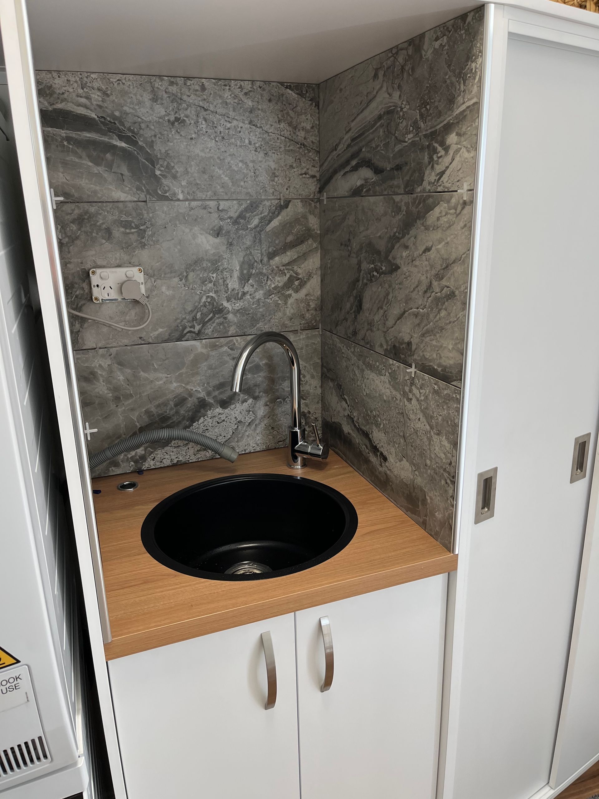 A Laundry Room Featuring a Washing Machine, Dryer, Refrigerator, and Sink — Laundry Renovations on the Sunshine Coast QLD