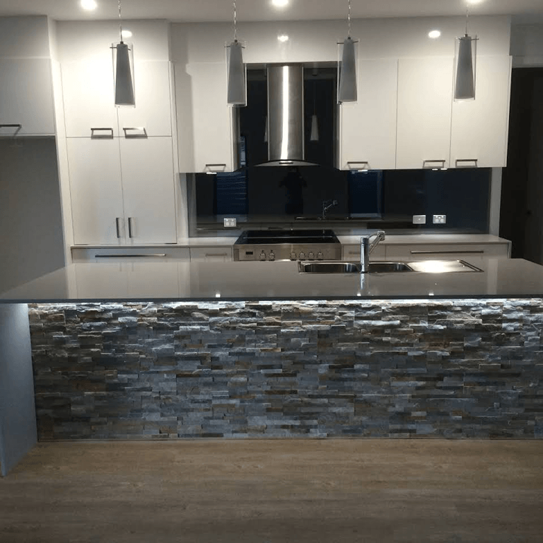 A Kitchen with White Cabinets and a Stovetop Oven — Expert Cabinetmaker on the Sunshine Coast QLD