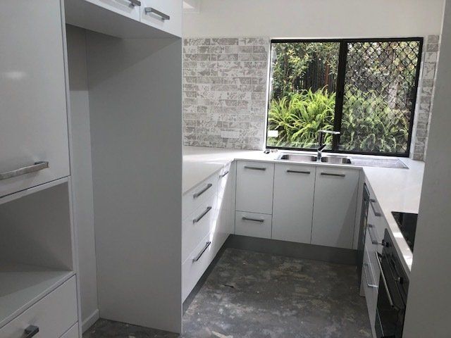 A Kitchen Featuring White Cabinets, Sink, and Window — Expert Cabinetmaker on the Sunshine Coast QLD