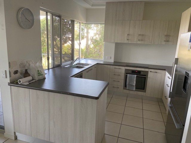 A Kitchen Featuring Clocks on the Wall and Counter — Expert Cabinetmaker on the Sunshine Coast QLD