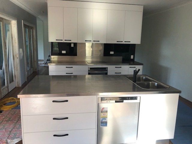 A Kitchen with White Cabinets and Stainless Steel Countertops — Expert Cabinetmaker on the Sunshine Coast QLD