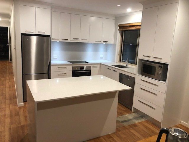 A Kitchen with White Cabinets and Stainless Steel Appliances, Showcasing Modern Elegance and Functionality — Expert Cabinetmaker on the Sunshine Coast QLD