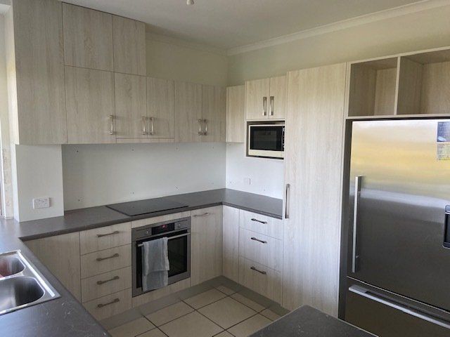A Kitchen Featuring Stainless Steel Appliances and White Cabinets — Expert Cabinetmaker on the Sunshine Coast QLD
