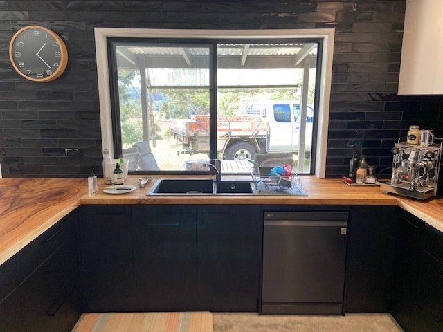 A Rustic Kitchen featuring a Sink and Wall Clock — Expert Cabinetmaker on the Sunshine Coast QLD