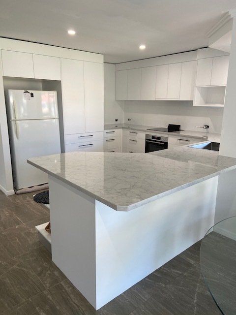 A Kitchen Featuring White Cabinets and a Refrigerator — Expert Cabinetmaker on the Sunshine Coast QLD