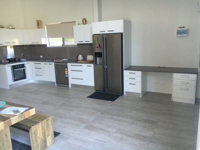 A Kitchen With White Cabinets and a Stainless Steel Refrigerator — Expert Cabinetmaker on the Sunshine Coast QLD