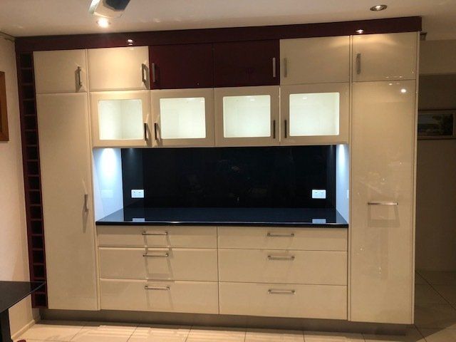A Kitchen with White Cabinets and Black Countertops, Showcasing Modern Elegance — Expert Cabinetmaker on the Sunshine Coast QLD