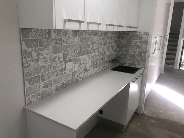 A Kitchen with White Cabinets and a White Countertop, Showcasing Modern Elegance — Expert Cabinetmaker on the Sunshine Coast QLD