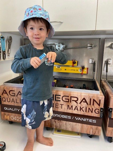 Child Standing in Front of the Tool Box — Against the Grain Cabinetry in Rosemount, QLD