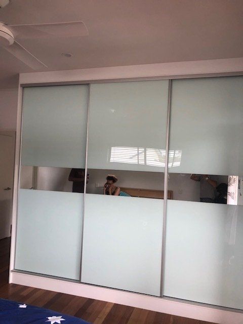 A Bedroom featuring Sliding Glass Doors and a Ceiling Fan — Expert Cabinetmaker on the Sunshine Coast QLD