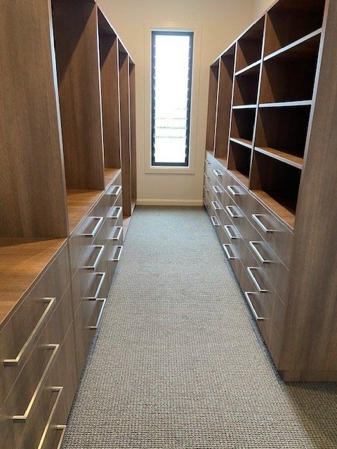 A Spacious Walk-In Closet featuring Abundant Drawers and Shelves — Custom Cabinetry on the Sunshine Coast QLD