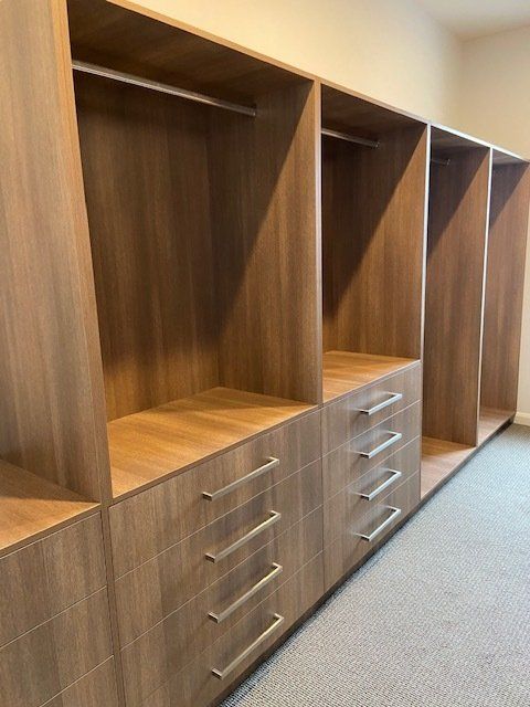 A Spacious Walk-in Closet Featuring Abundant Wooden Shelves and Drawers — Expert Cabinetmaker on the Sunshine Coast QLD