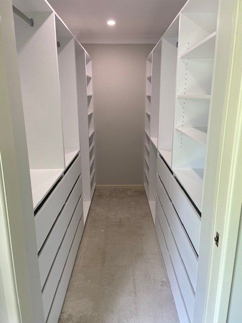A Walk-in Closet Featuring Abundant Shelves and Drawers — Expert Cabinetmaker on the Sunshine Coast QLD