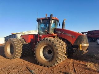 A Large Red Tractor is Parked in a Dirt Fiel — Dynamic Performance Systems In Kelso, NSW