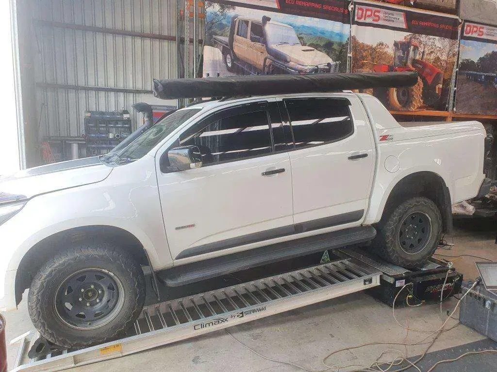 A White Truck is Parked on a Ramp in a Garage — Dynamic Performance Systems In Kelso, NSW