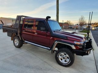 A Red Truck With a Tray on the Back is Parked in a Parking Lot — Dynamic Performance Systems In Kelso, NSW
