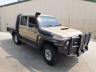 A Tan Truck With a Snorkel is Parked in Front of a Building — Dynamic Performance Systems In Kelso, NSW