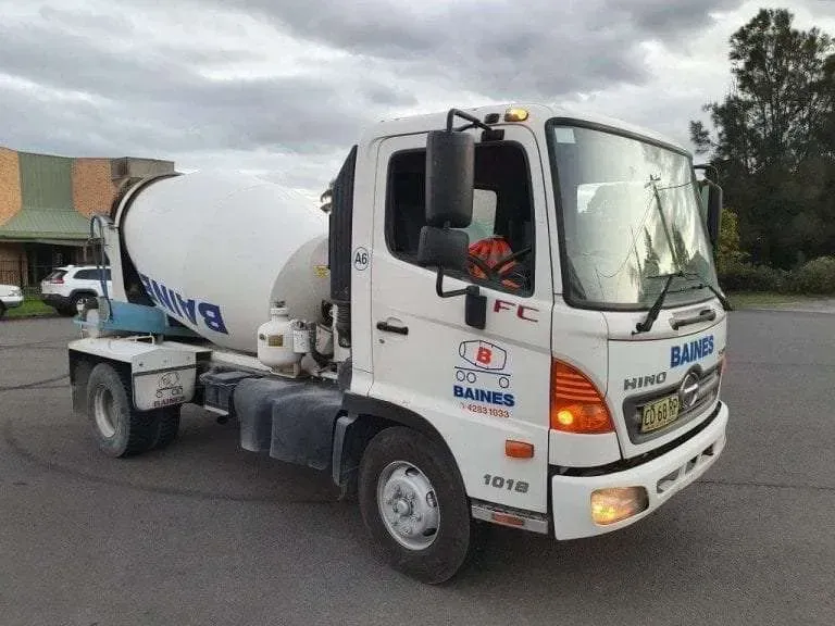 A White Concrete Mixer Truck is Parked in a Parking Lot — Dynamic Performance Systems In Kelso, NSW