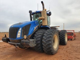 A Blue Tractor is Parked in a Dirt Field — Dynamic Performance Systems In Kelso, NSW