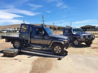 Two Trucks Are Parked Next to Each Other on a Dirt Road — Dynamic Performance Systems In Kelso, NSW