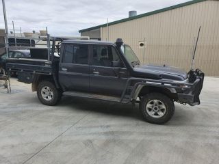 A Black Truck is Parked in a Parking Lot in Front of a Building — Dynamic Performance Systems In Kelso, NSW