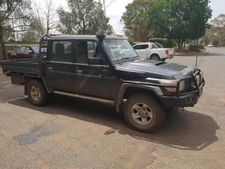 A Black Truck With a Flat Bed is Parked in a Parking Lot — Dynamic Performance Systems In Kelso, NSW