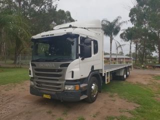 A White Flatbed Truck is Parked in a Grassy Area — Dynamic Performance Systems In Kelso, NSW