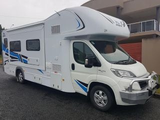 A White Rv is Parked in Front of a Building — Dynamic Performance Systems In Kelso, NSW