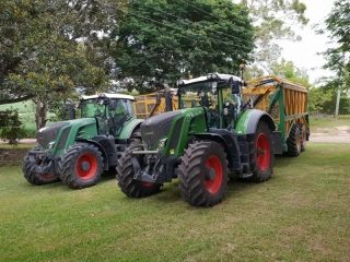 Two Tractors Are Parked Next to Each Other in a Grassy Field — Dynamic Performance Systems In Kelso, NSW