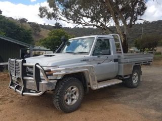 A Silver Truck is Parked in a Dirt Lot Next to a Tree — Dynamic Performance Systems In Kelso, NSW