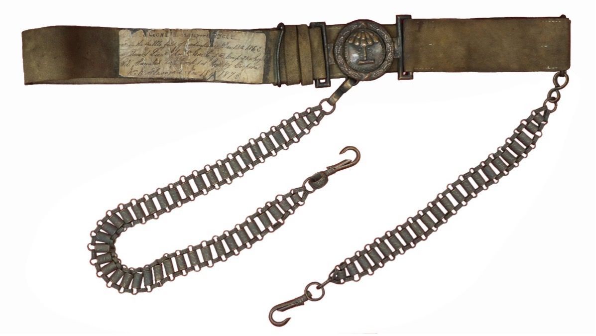 A brown belt with a chain attached to it