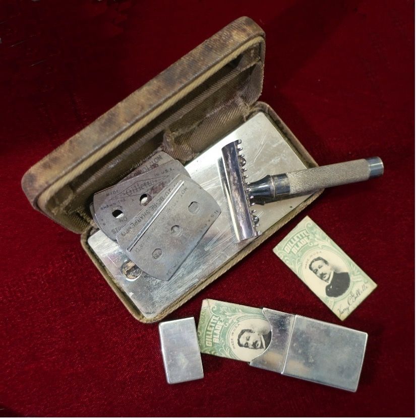 A shaving razor in a case next to a dollar bill