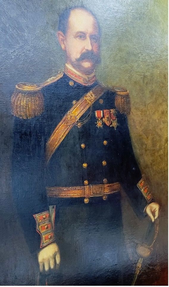 Portrait of a man in a dark military uniform with gold epaulets and decorations, holding a sword.