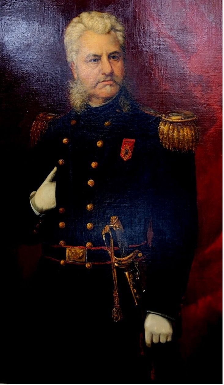 Portrait of a man in a dark military uniform with gold epaulettes, holding a sword.