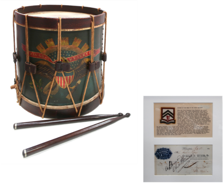 Antique drum with eagle design and drumsticks, plus two framed historical documents.