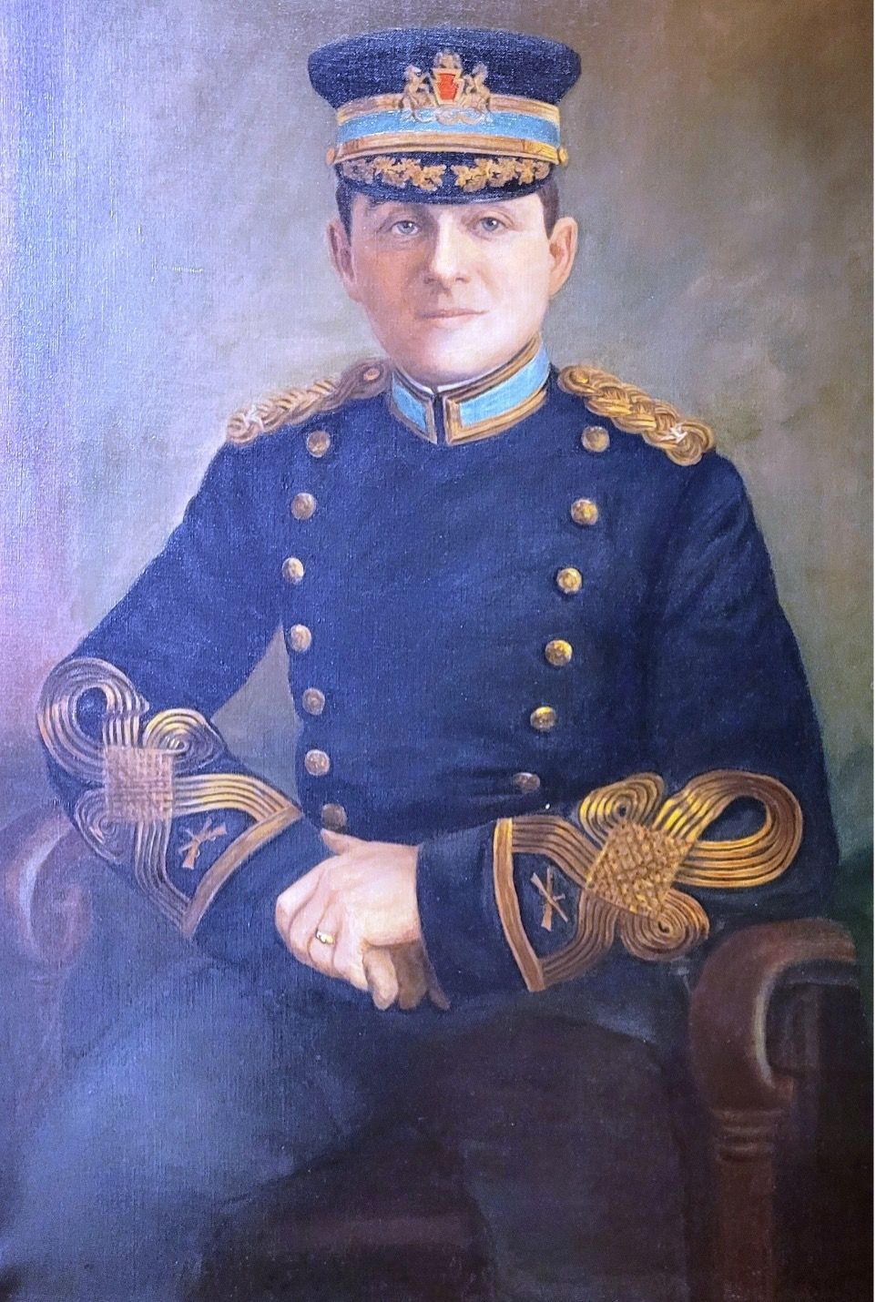 Portrait of a man in a blue military uniform, seated, with gold trim and epaulettes.